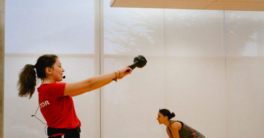 Instructor leads kettle bell training class